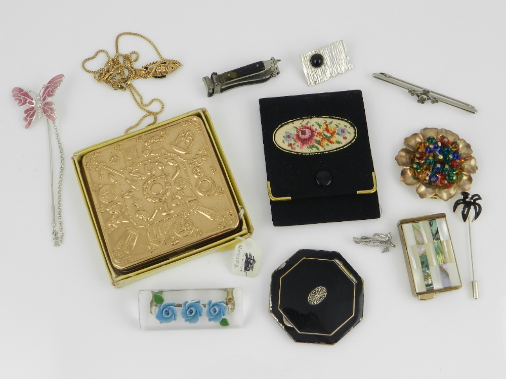 A quantity of costume jewellery to include brooches and a perfume atomizer. A vogue art deco compact