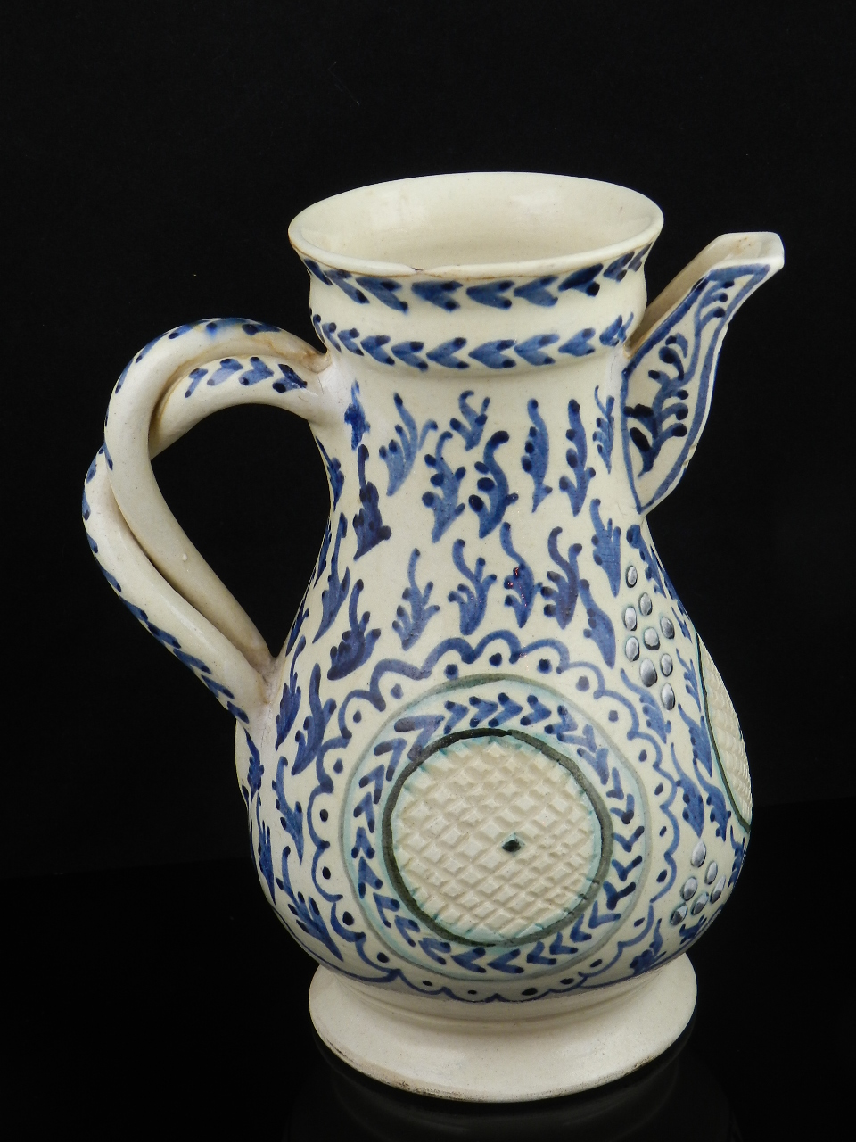 A Turkish or Persian pear-shaped water jug with entwined scroll handle having blue and white