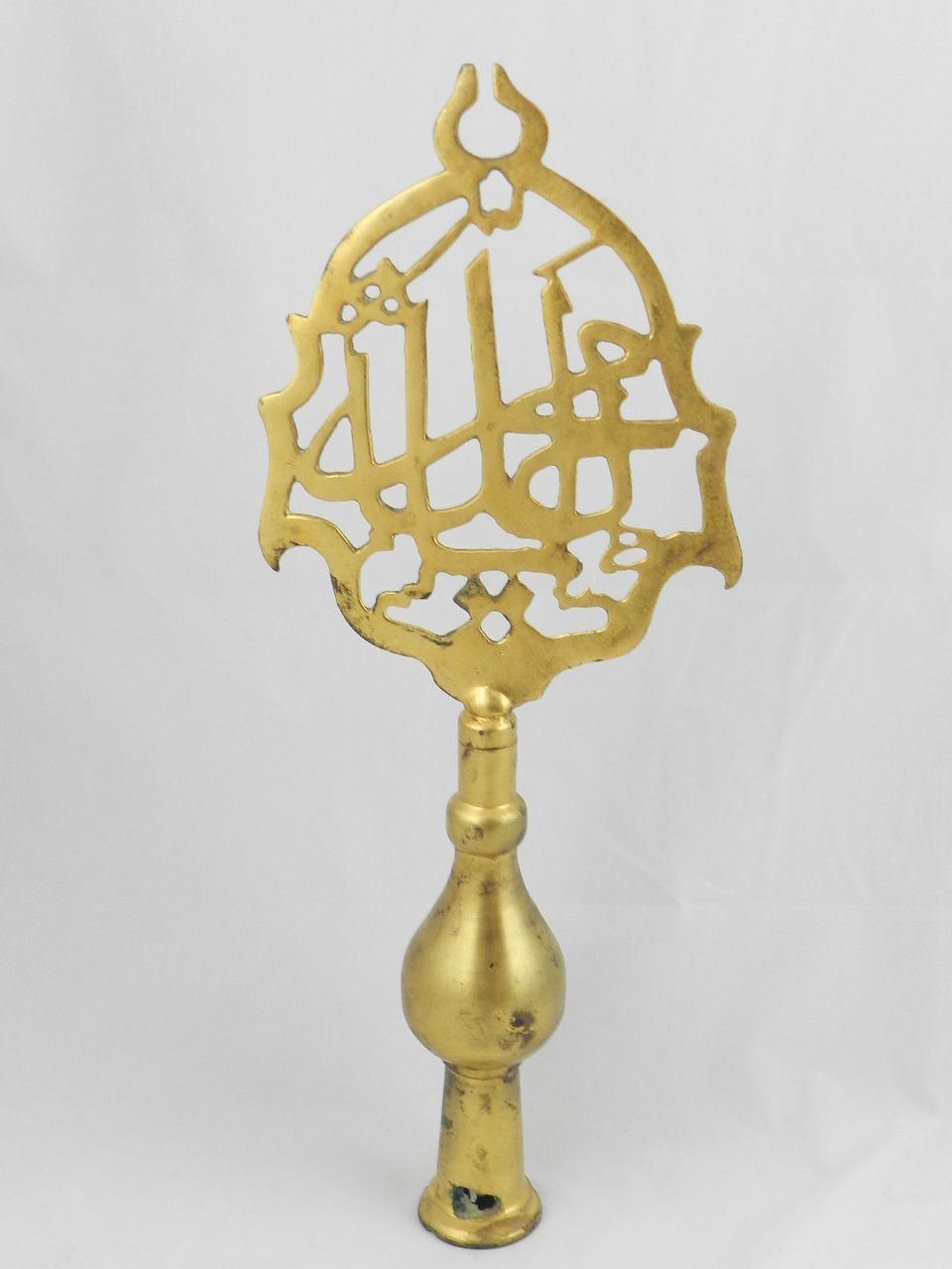 A Turkish gilt copper Tombak Alem pierced scroll top