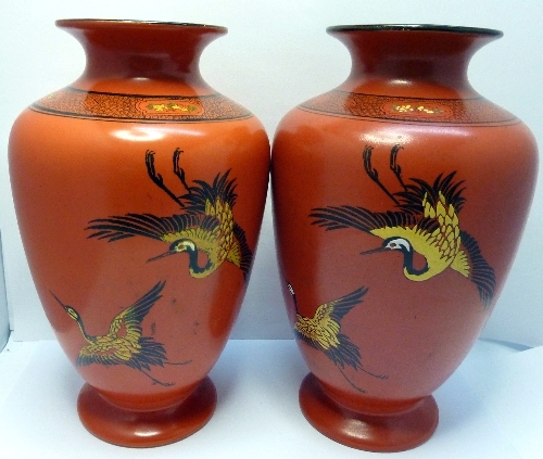 A pair of Shelley vases decorated with herons on a red ground, height 23cms, one a/f