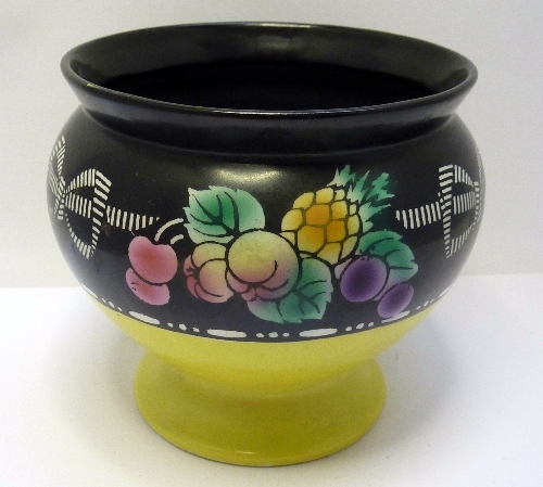 A Shelley vase decorated with a band of fruit on a yellow and black ground, height 11cms