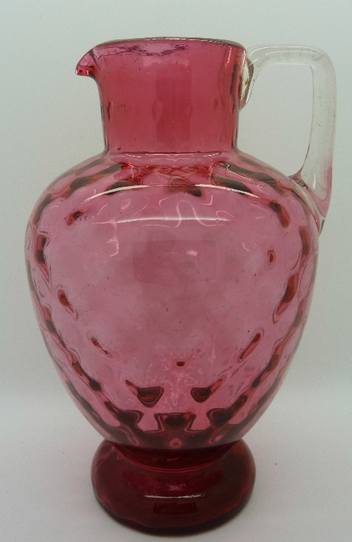 A cranberry glass jug, height 17cms