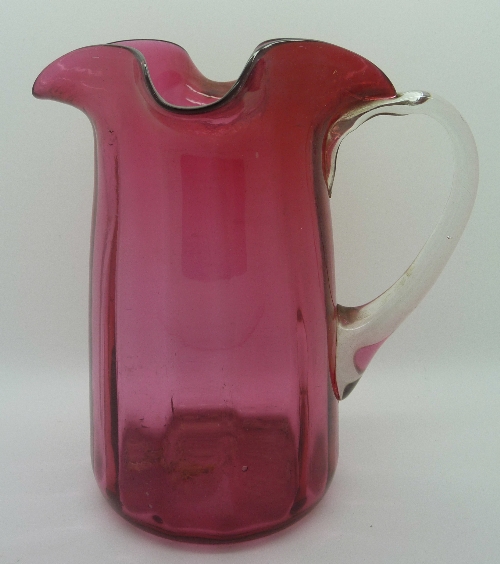 A cranberry glass jug, height 16cms