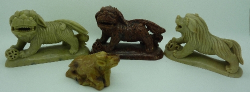 Three oriental carvings of dogs of foe and one kneeling oxen, height of tallest 8cms