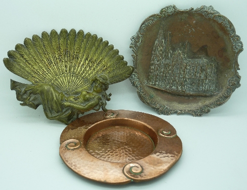 A brass dish in the form of a lady with a fan, a plated dish relief moulded with a cathedral and a