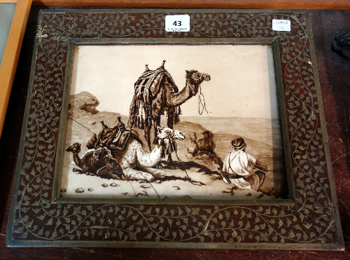 A painted tile, titled A Rest in the Desert, framed