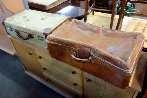 A leather suitcase and a military style suitcase