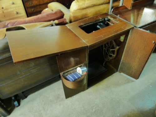 A Singer sewing machine with cabinet