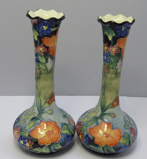 A pair of Old Tupton Ware vases decorated with tube lined flowers, height 21cms