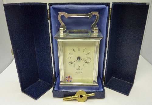 A carriage clock retailed by Rapport, London, height with handle raised 15cms, cased