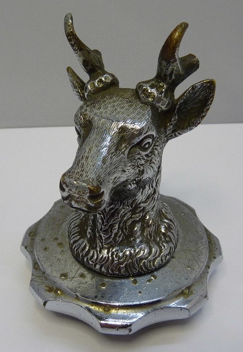 A chromium plated car mascot in the form of a stags head, height 11cms