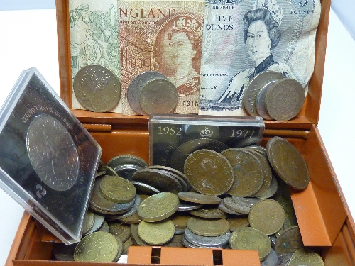 A tin of assorted coins and banknotes