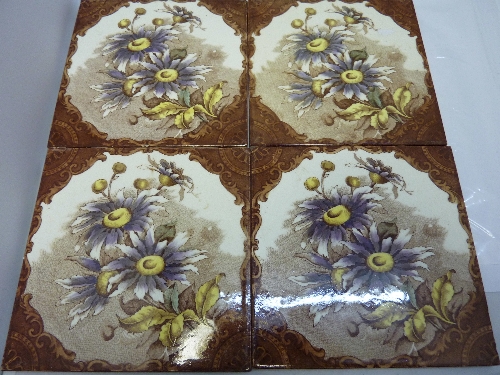 Four Edwardian tiles decorated with transfer printed flowers