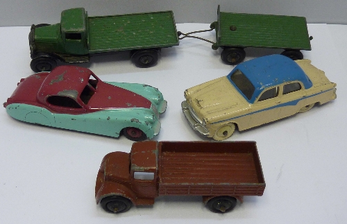 Five Dinky Toys die cast vehicles, including an Austin A105 and a 157 Jaguar, playworn