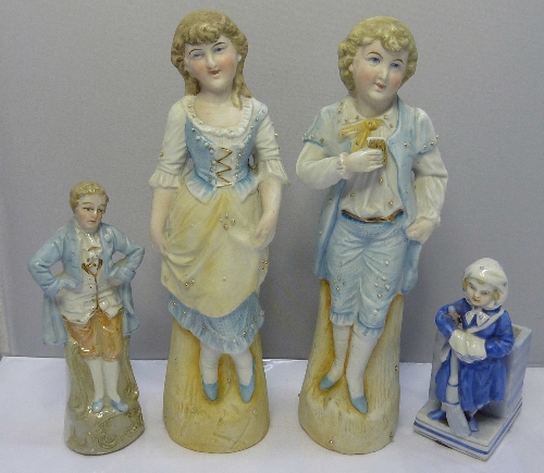 A pair of continental bisque figures of a boy and girl in classical dress, height 22cms and two