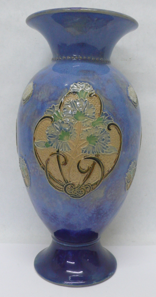 A Royal Doulton stoneware vase decorated in relief with flowers, height 28cms