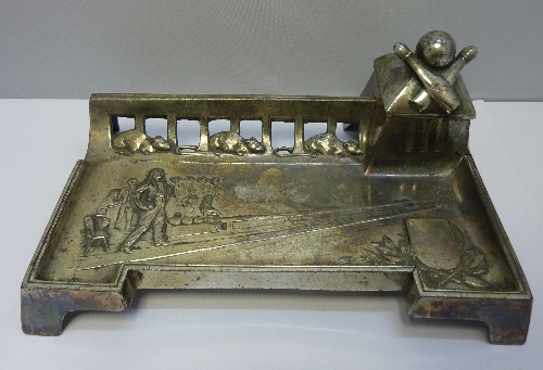 A W.M.F. style inkwell depicting a skittle alley, the pierced gallery decorated with three mice,