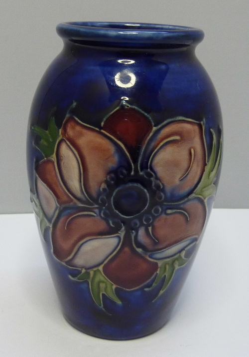 A Moorcroft vase decorated in the anemone pattern on a blue ground, height 11cms