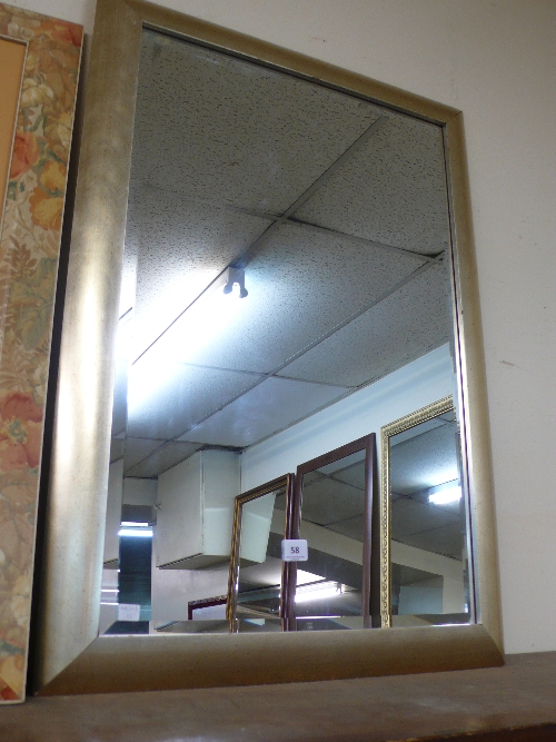 A silvered framed mirror