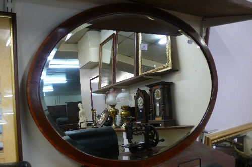 A mahogany framed oval mirror