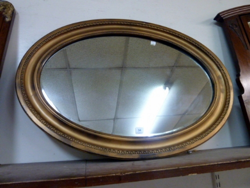 A gilt framed oval mirror