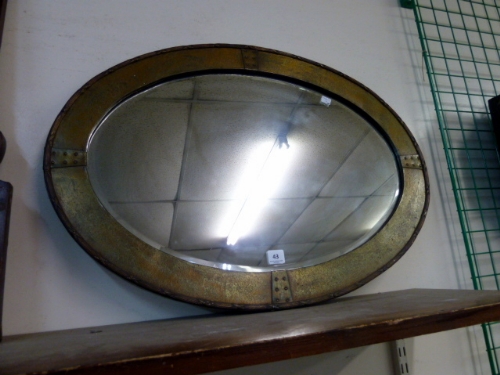 An Arts and Crafts style pewter framed mirror