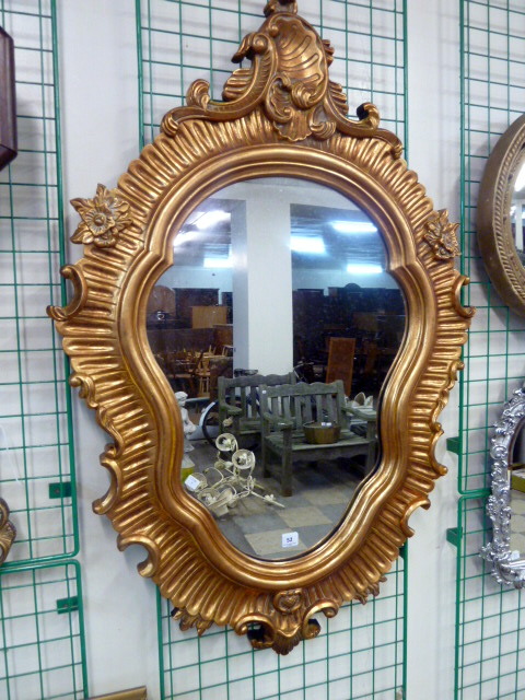 A reproduction Rococo style gilt frame mirror