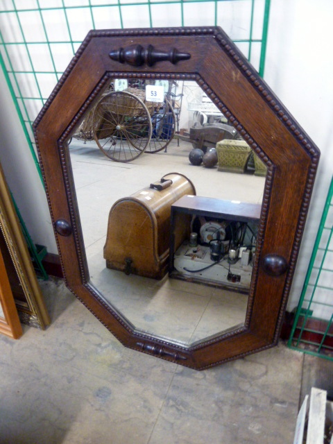 An oak octagonal framed mirror