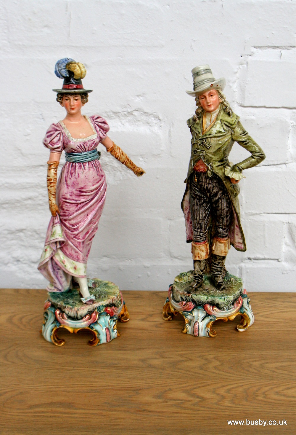 A pair of Italian porcelain figures as a Georgian lady and gentleman in period dress 13in(33cm)H.