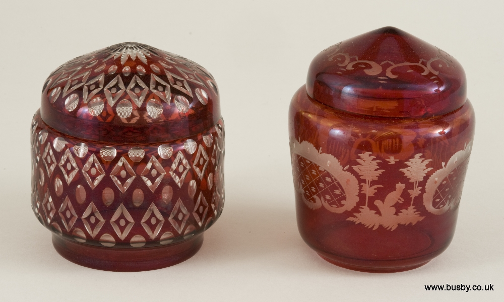 Two 19th century lapidary cut ruby glass lidded dishes; the earlier decorated with fox, hare and