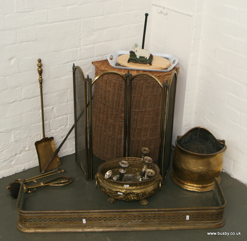 A collection of fireside accessories to include a coal scuttle, a brass fender, fire guard, and