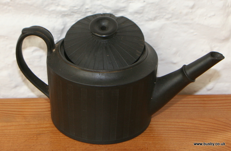 An 18th century black basalt small teapot, unmarked, of neo-classical design and with engine