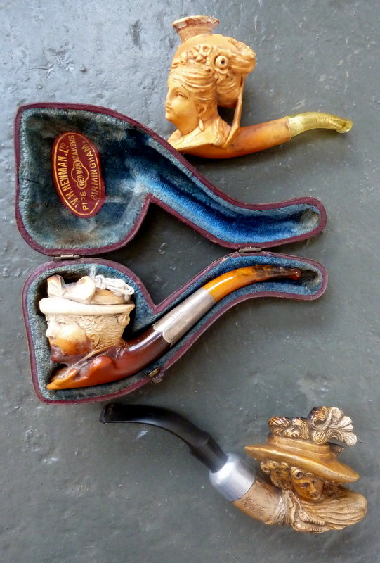 Three meerschaum pipes modelled as bonneted Edwardian ladies 5½in(14cm)L and smaller.