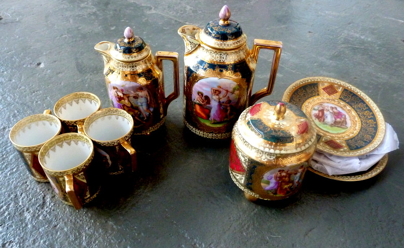 A 20th century Vienna porcelain four setting coffee service decorated with fête gallant reserves and