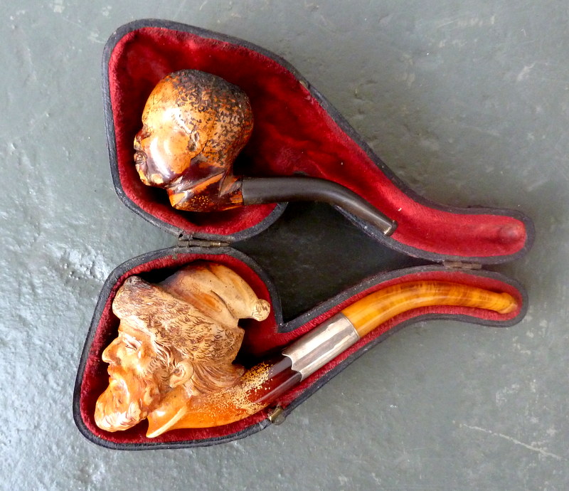 Two meerschaum pipes; one modelled as Uncle Tom, the other as Santa Claus 6¼in(16cm)L and smaller.