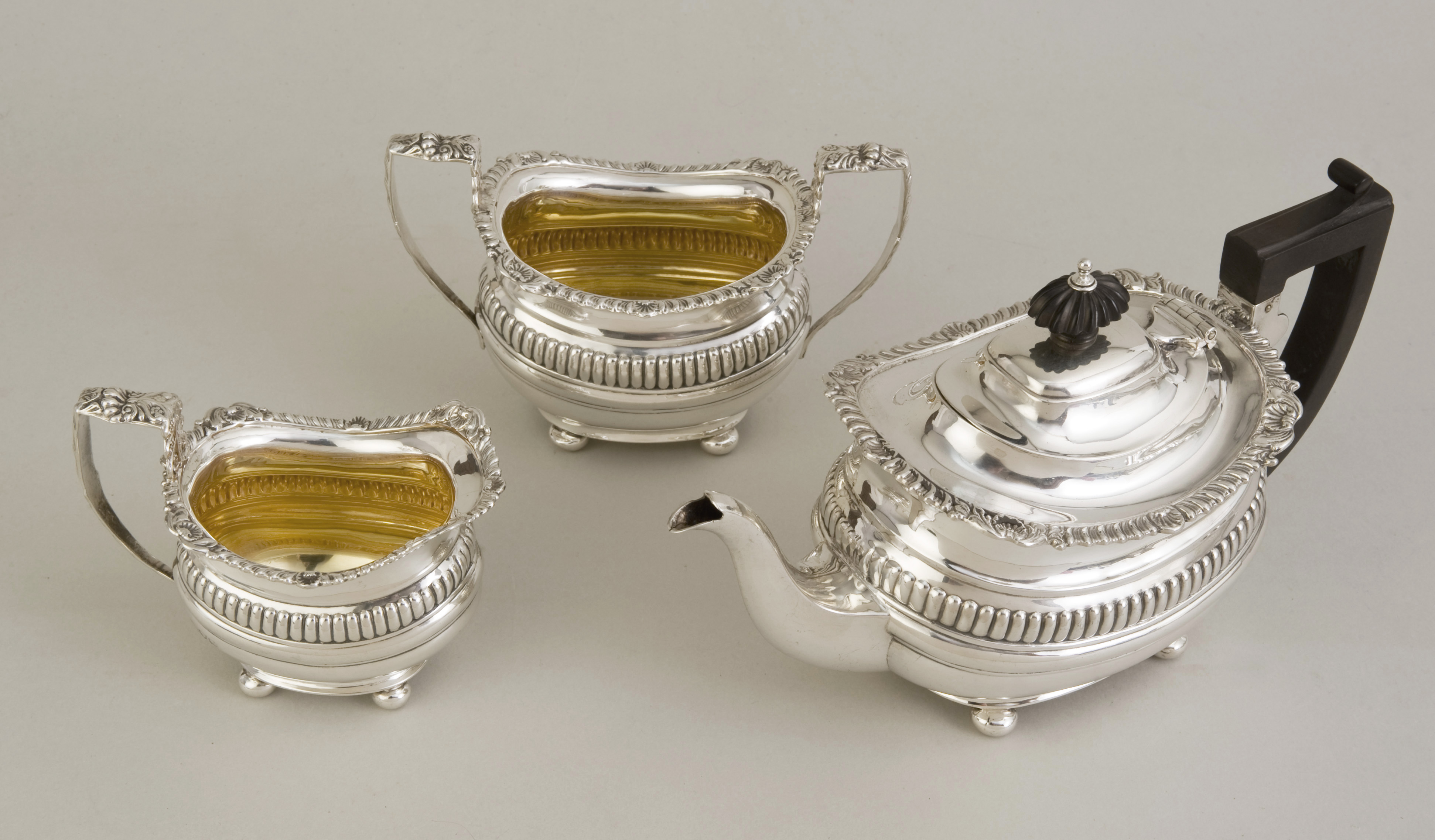 An Edwardian hallmarked silver neo-classical three piece tea set, Chester 1905, by George Nathan &
