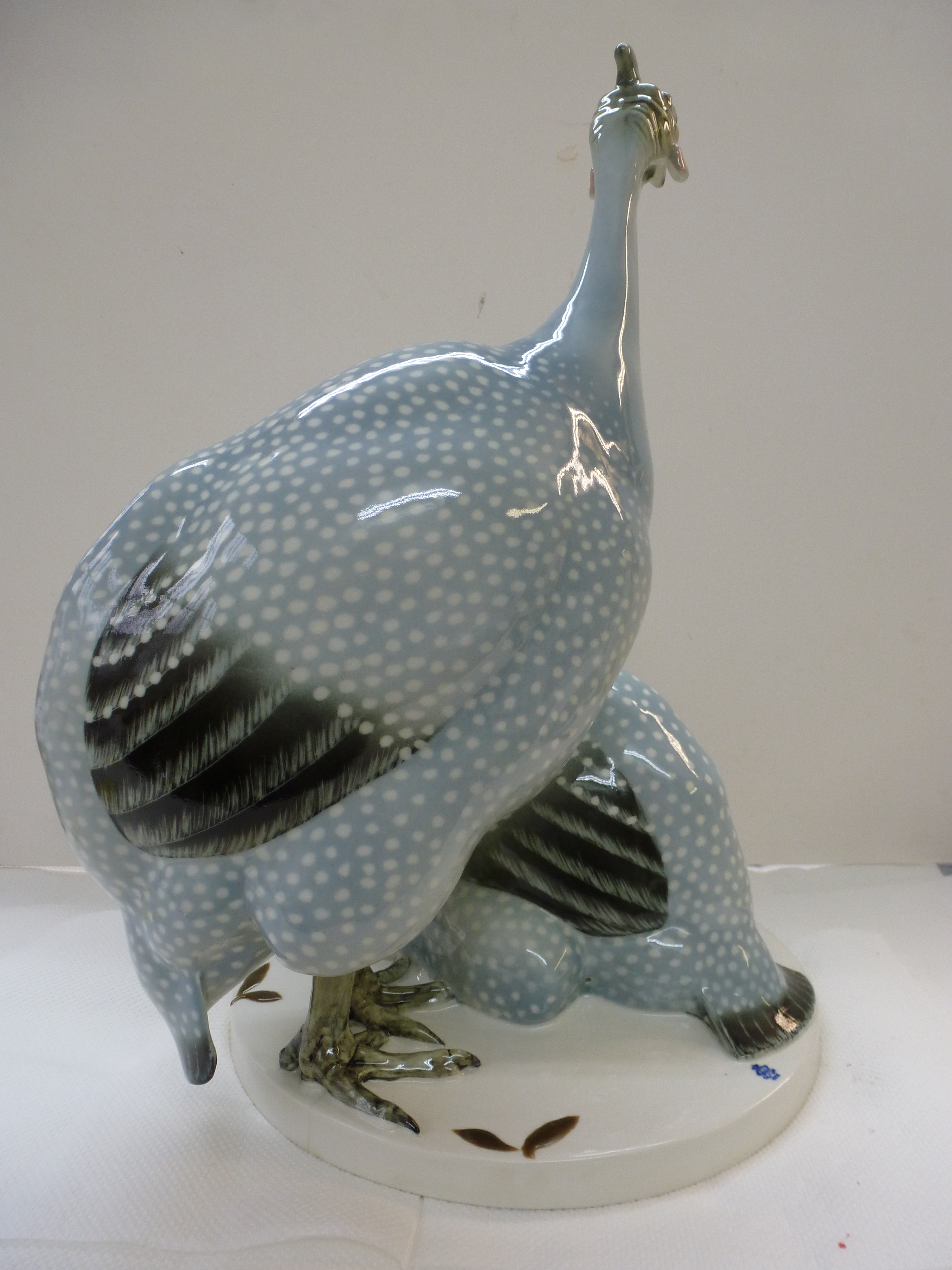 A rare Max Esser (1885-1943) guinea fowl polychrome porcelain animal group, produced for the