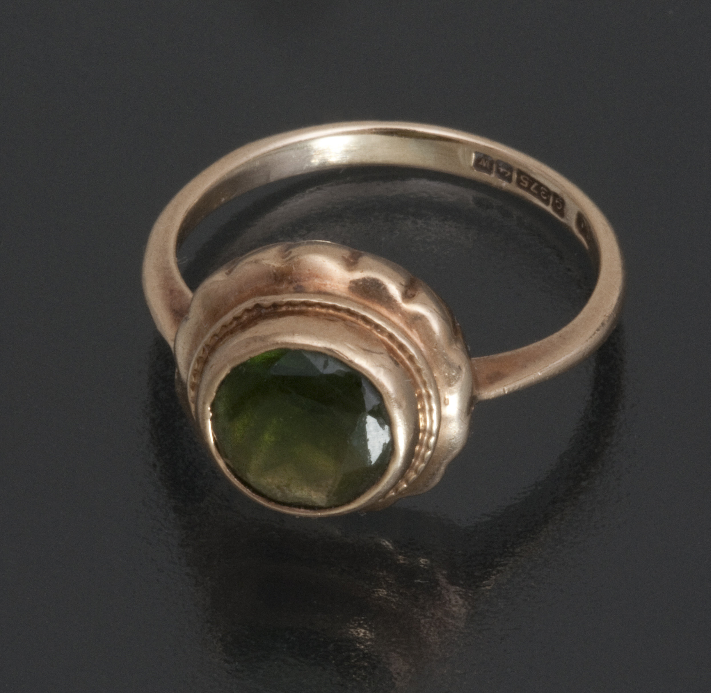 A 9ct gold bezel set solitaire tsavorite garnet ring, Birmingham 1971, size K (U.S. 5 ¾) 2.3g