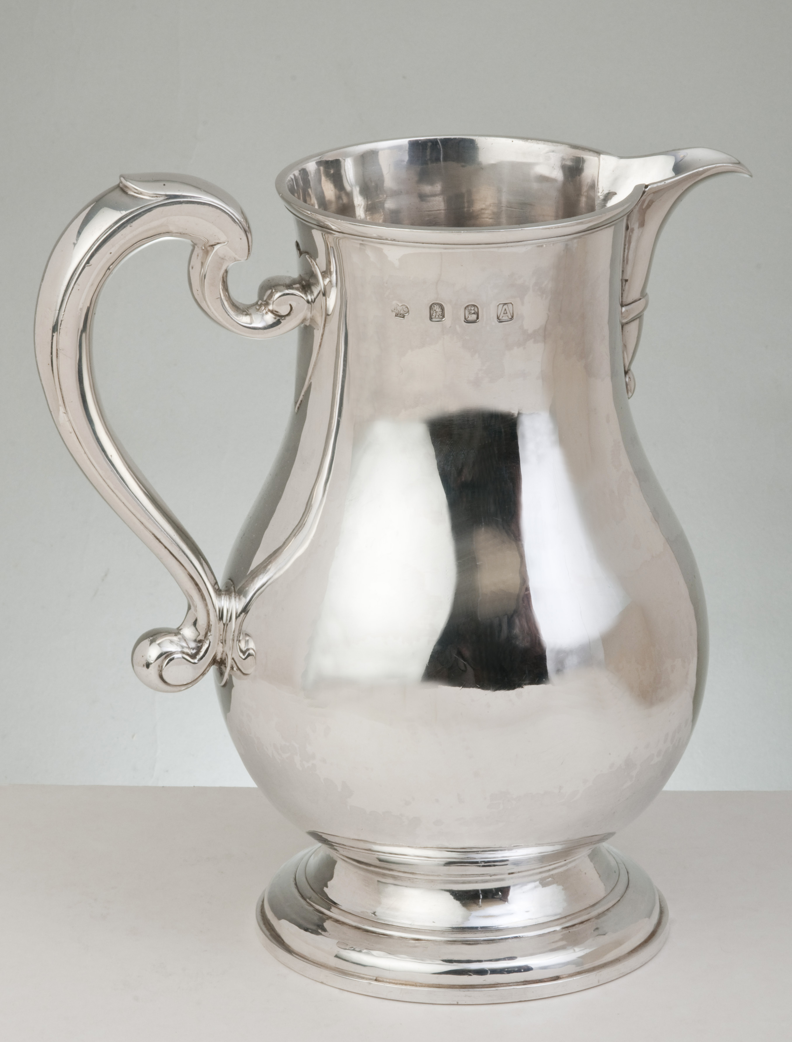 An Edward VIII hallmarked silver wine jug, London 1936 in the George I revival style of smooth