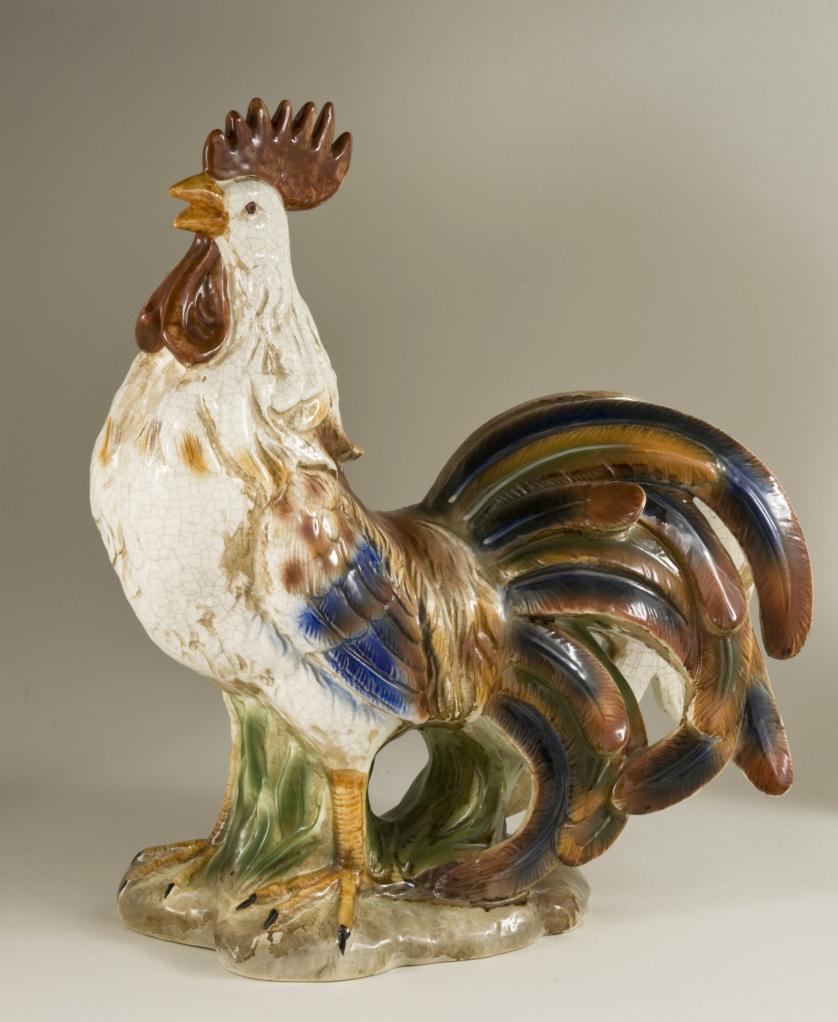 A large 20th century ceramic White Sussex cockerel in a muted polychrome palette and with a