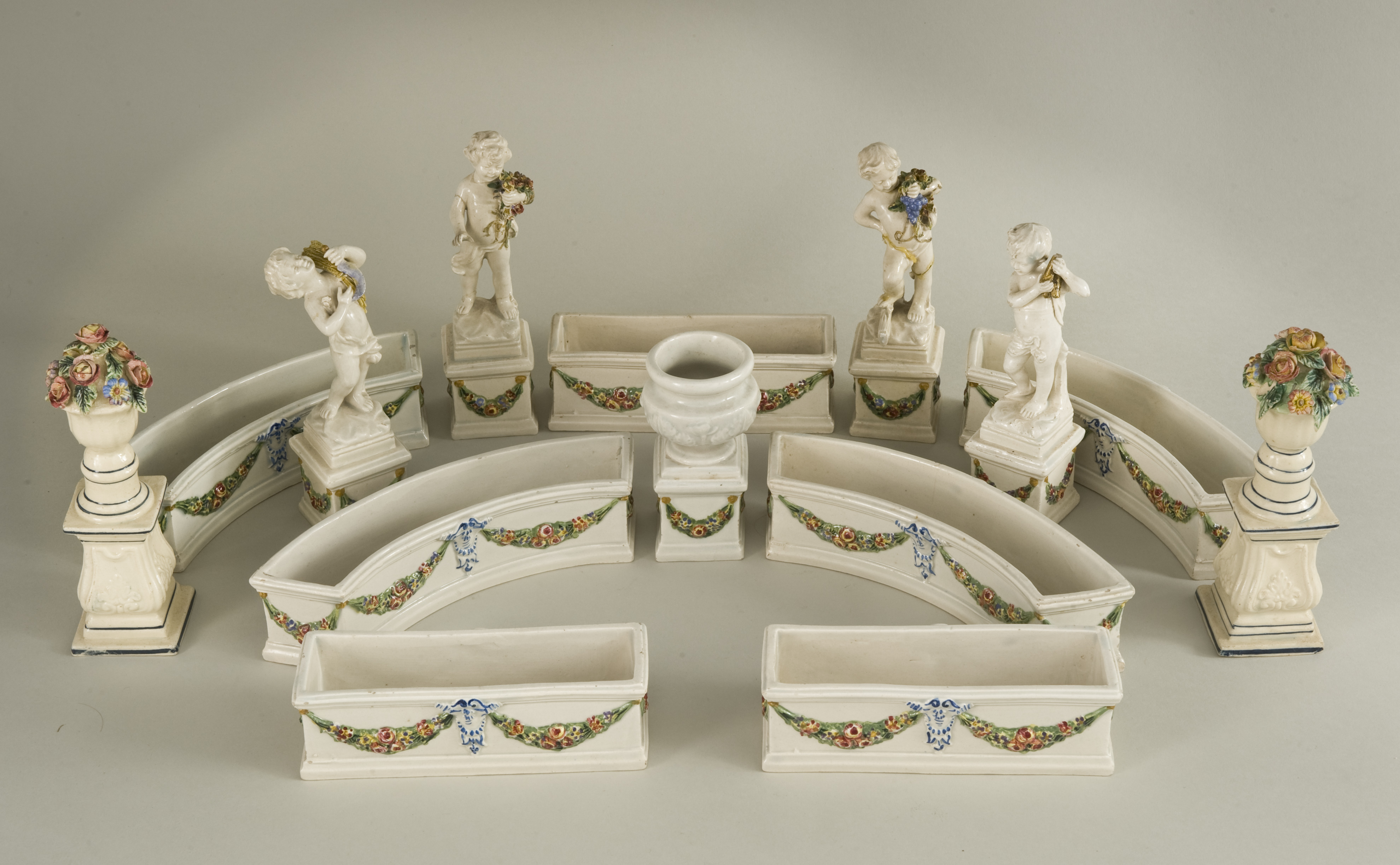 A 19th century Pearlware table centre display. A series of small curved and straight troughs with