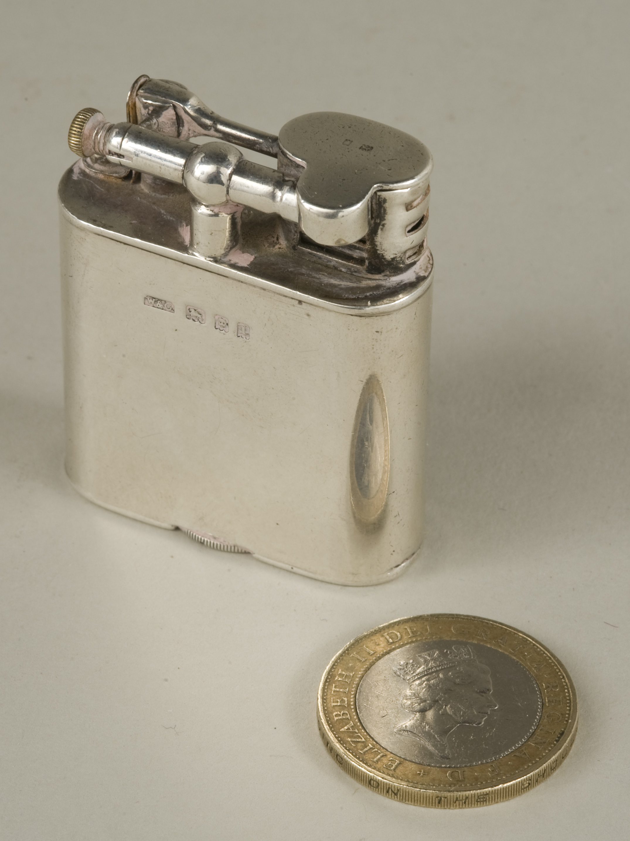 A silver Dunhill Unique Sports Lighter, London 1926, by Wise & Greenwood for Dunhill. 21/8in (5.5cm)