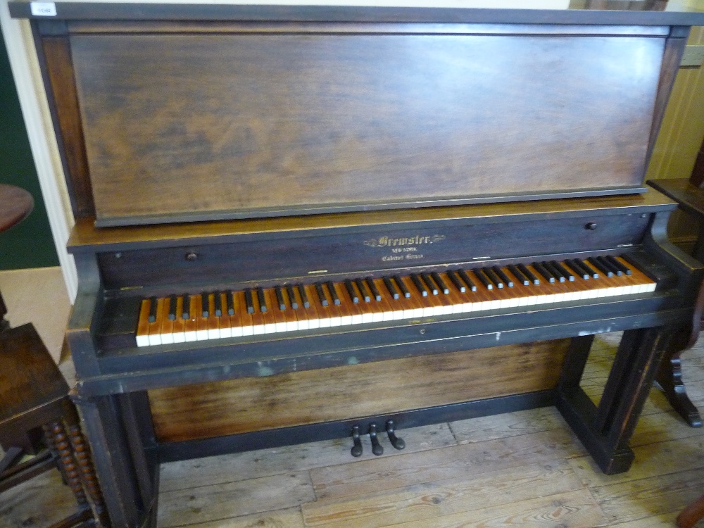 An upright Brewster Piano New York Company cabinet grand piano.