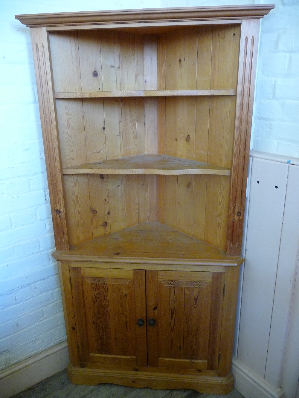 A Pine corner cupboard D. 17", W. 36" and H. 68".