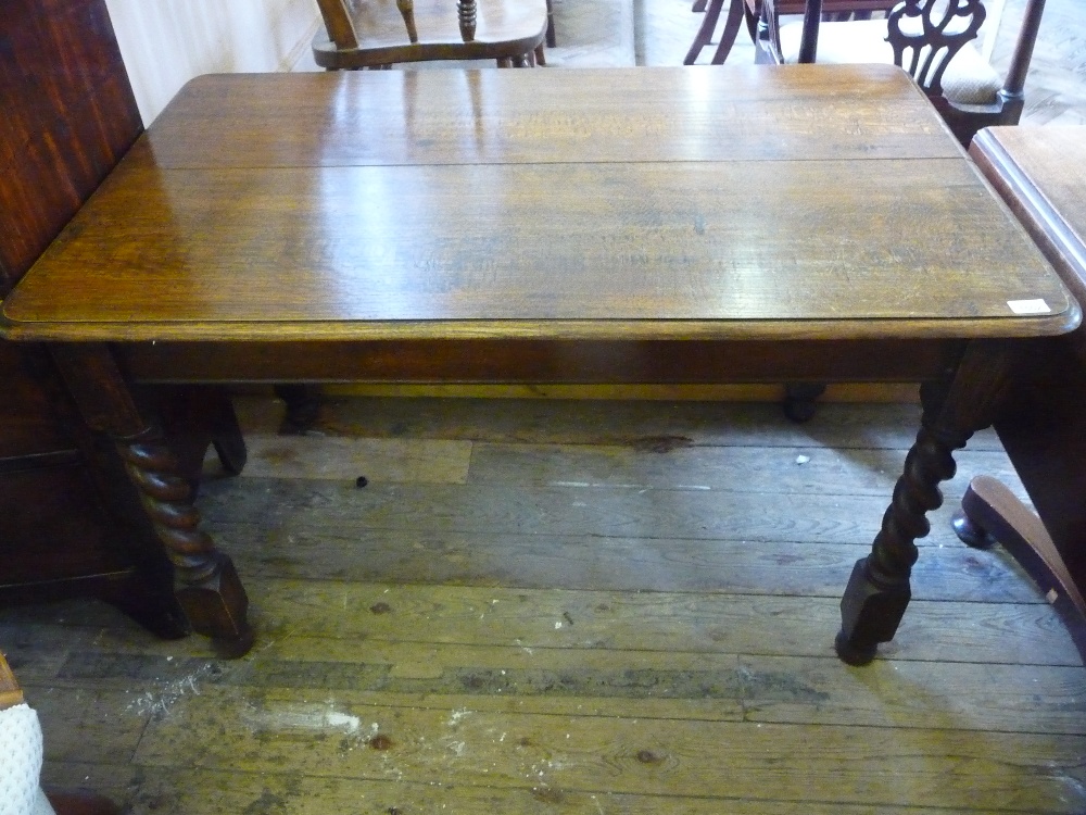 An Oak barley twist table, W.48" x D.29" and H. 28".