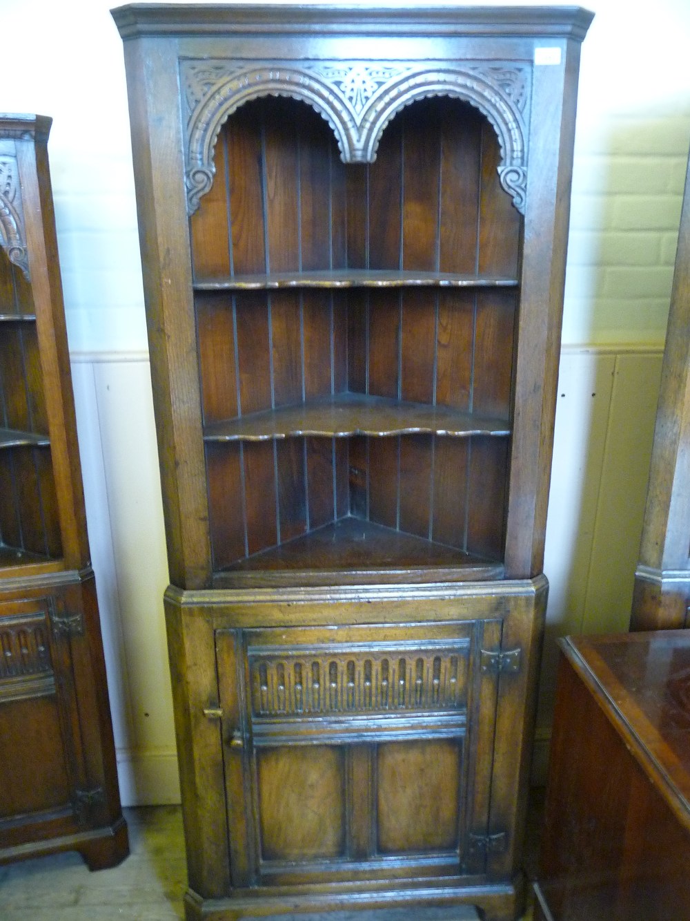 A carved Oak corner cabinet with single cupboard d. 20", w. 42 1/4" and 29".