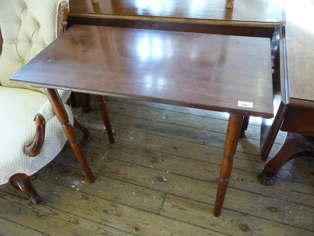 A Mahogany side table with turned supports.