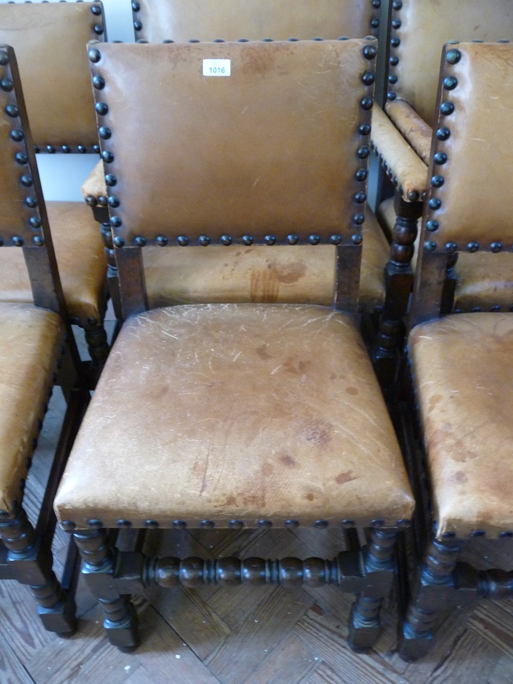 A set of six dark stained Oak bobbin turned leather dining chairs (four side chairs and two