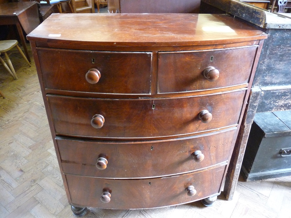 A bow fronted Mahogany chest of two long and three short drawers, D. 18 1/2", W. 34 1/2" and H. 42".