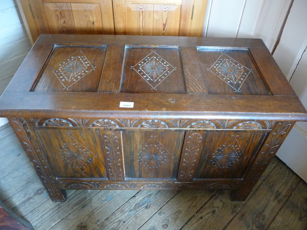 A small carved Oak coffer, D. 18", W. 36", H. 22 3/4".